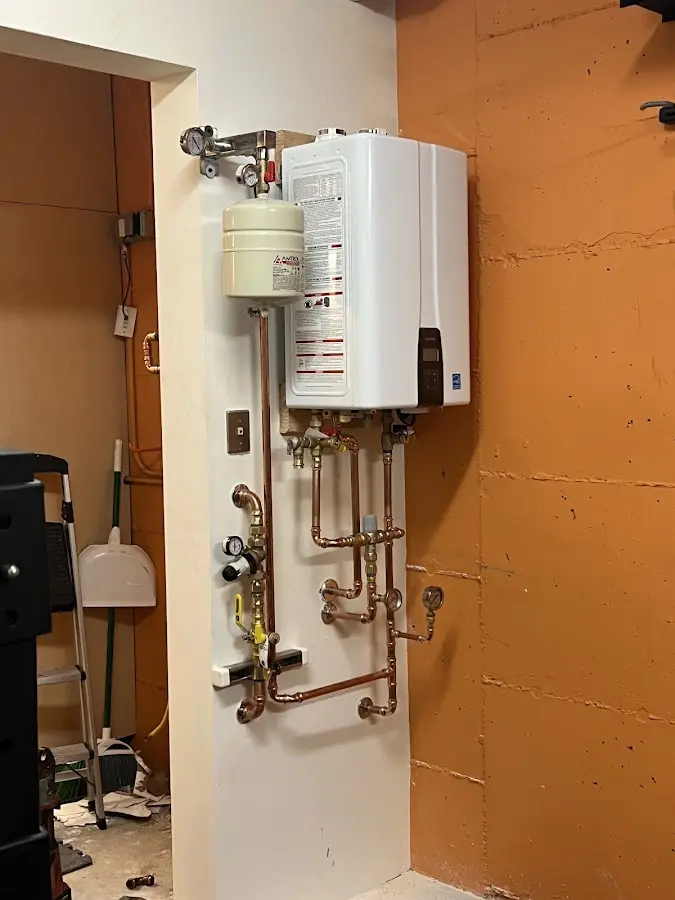 Plumbing technician inspecting water heater connections in Granite Bay
